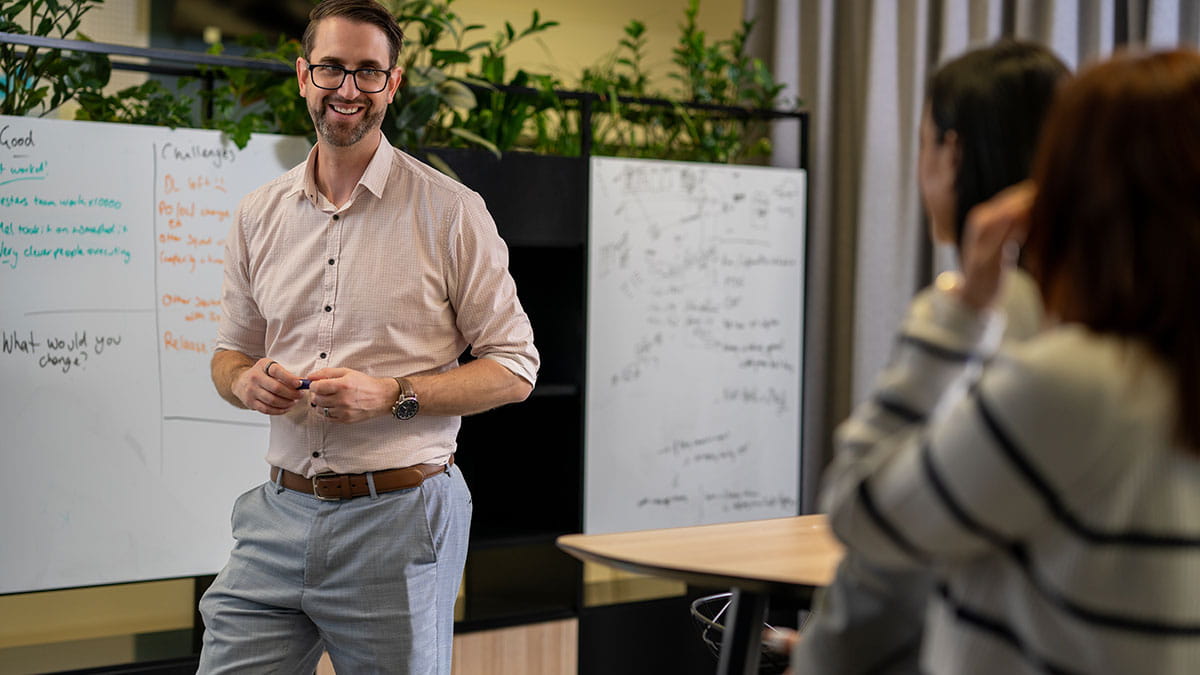 HBF staff hosting a workshop on a whiteboard