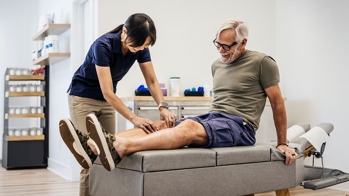 Older man getting his knee looked at