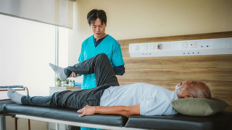 Man getting his leg looked at by doctor