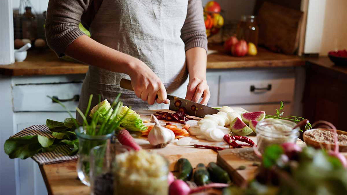 Woman chopping vegetables in kitchen