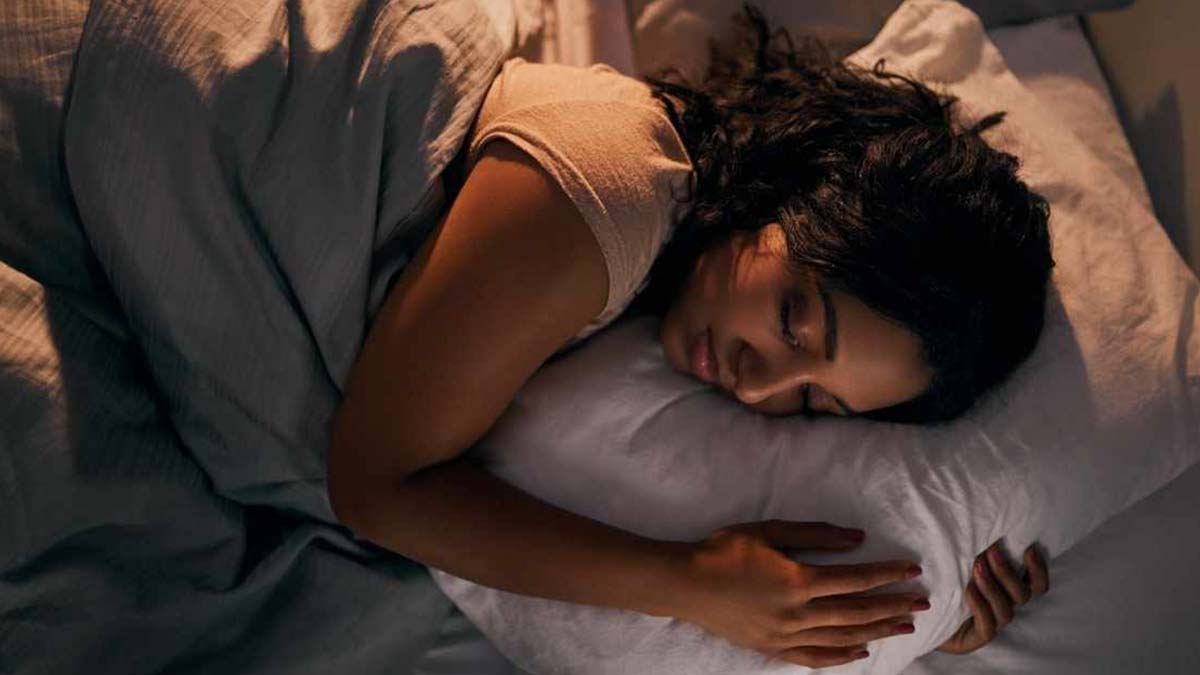 A young woman asleep in bed