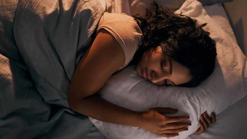A young woman asleep in bed