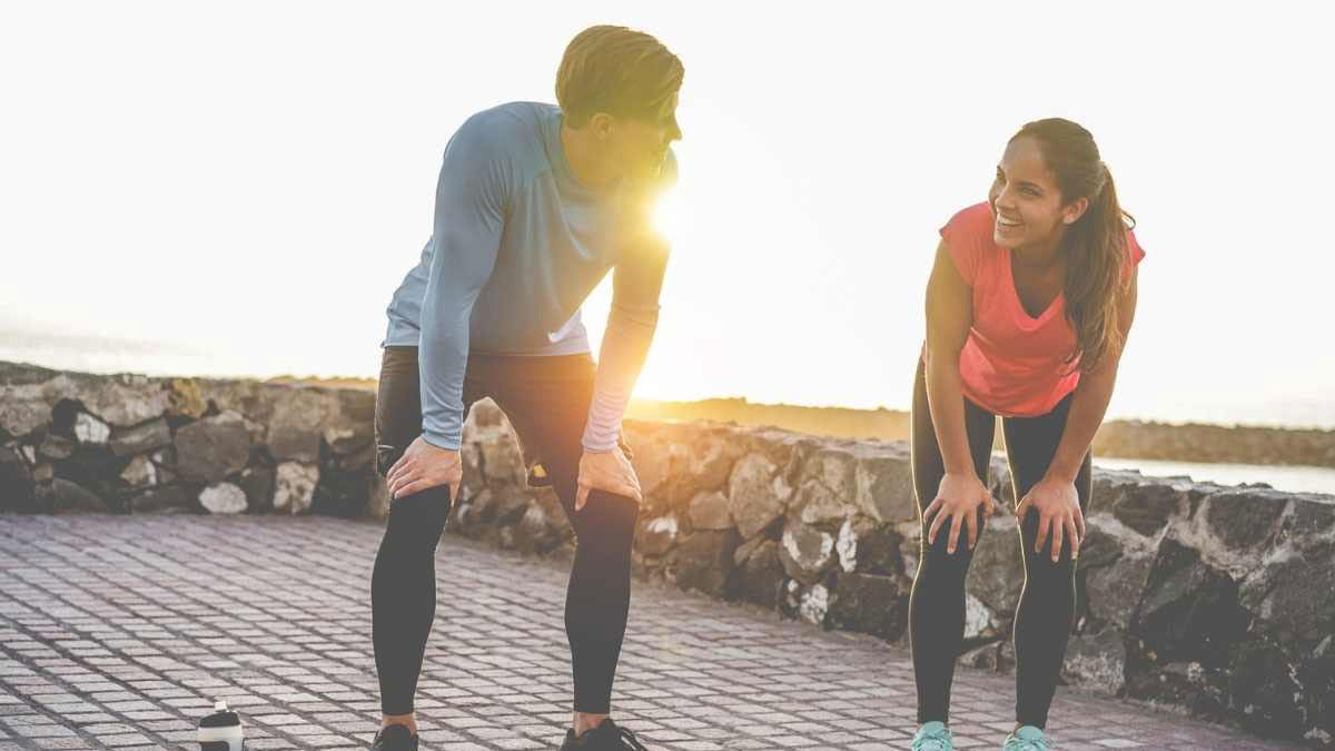 Two young people exercising at sunset
