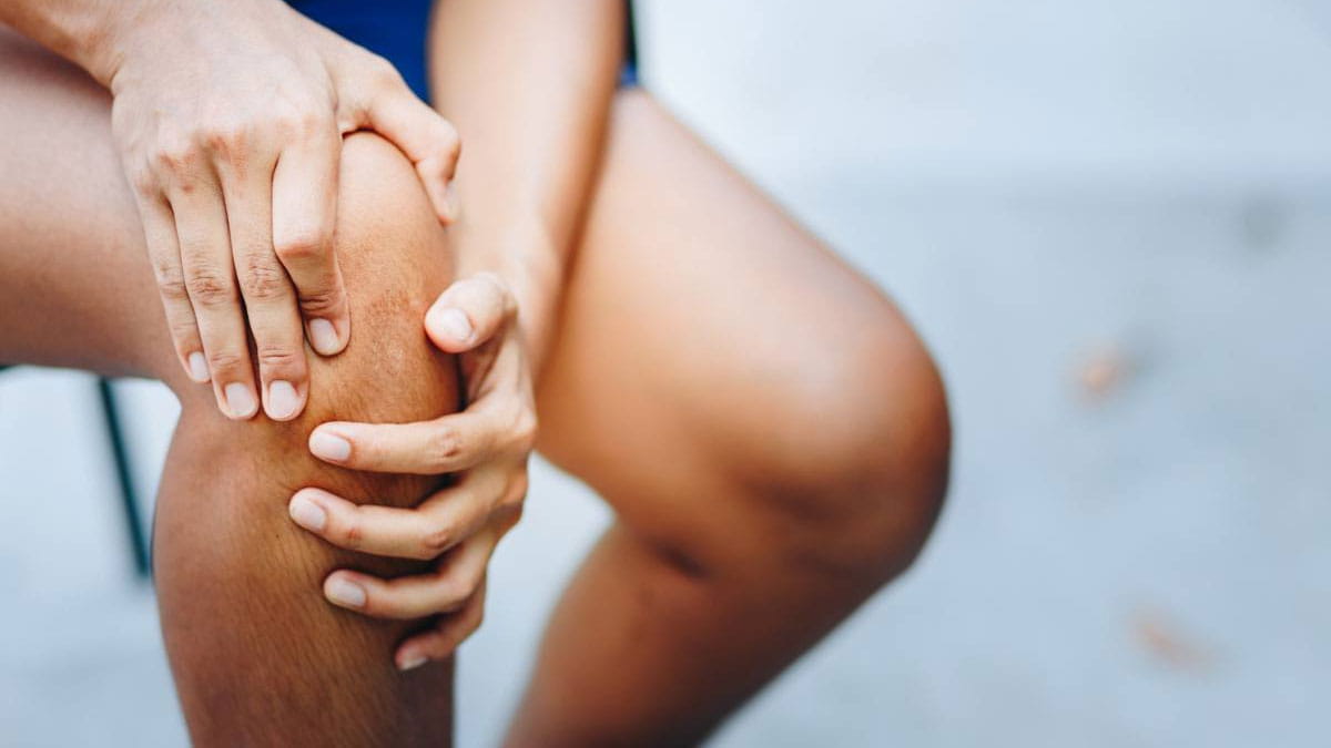 Person holding their knee