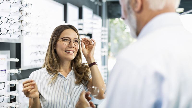 Woman trying new glasses on
