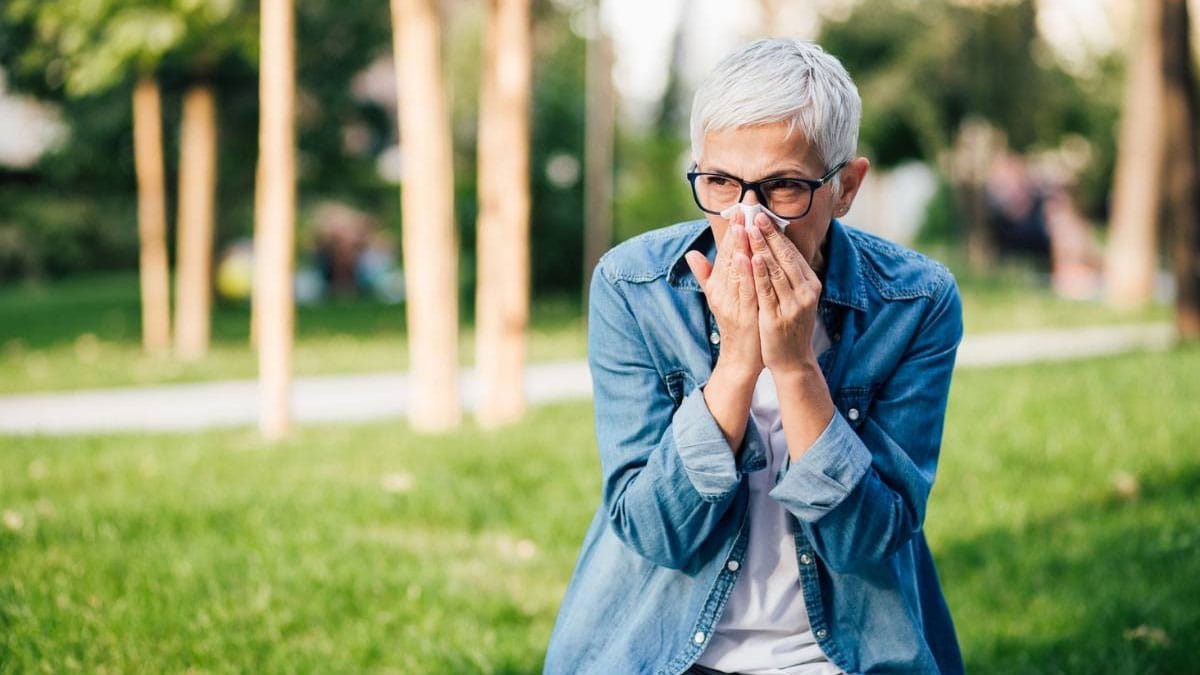 Woman blowing nose