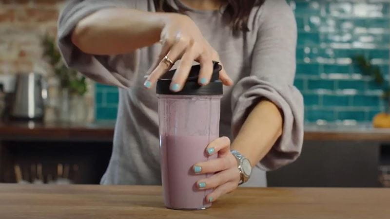 Woman making blueberry smoothie