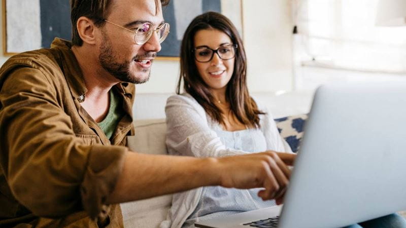 A couple using expert tips to compare health cover options