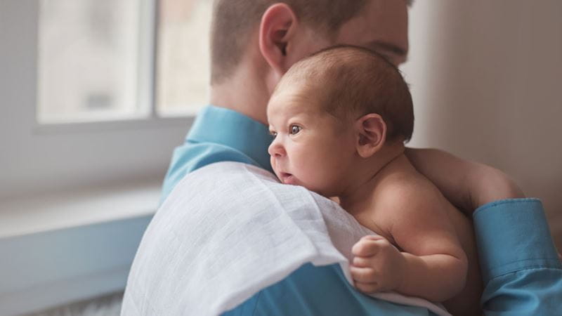 Dad winding or burping his baby