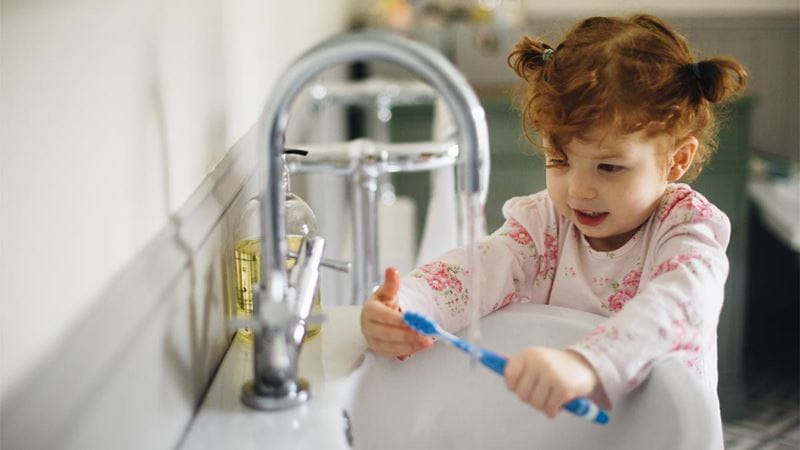 Child brushing teeth