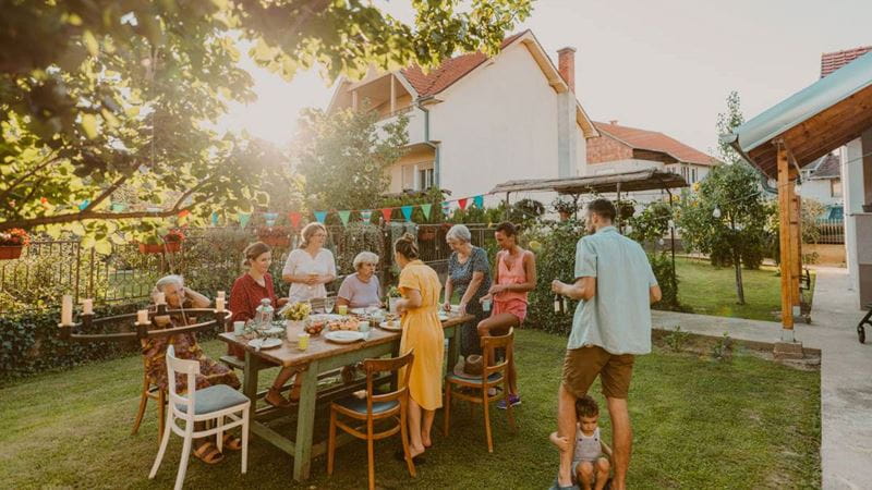 Family having lunch together in backyard