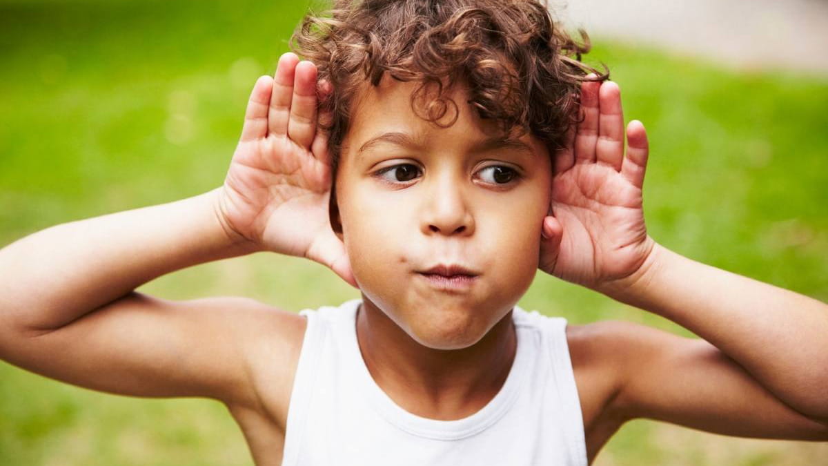 Boy with hands on his ears