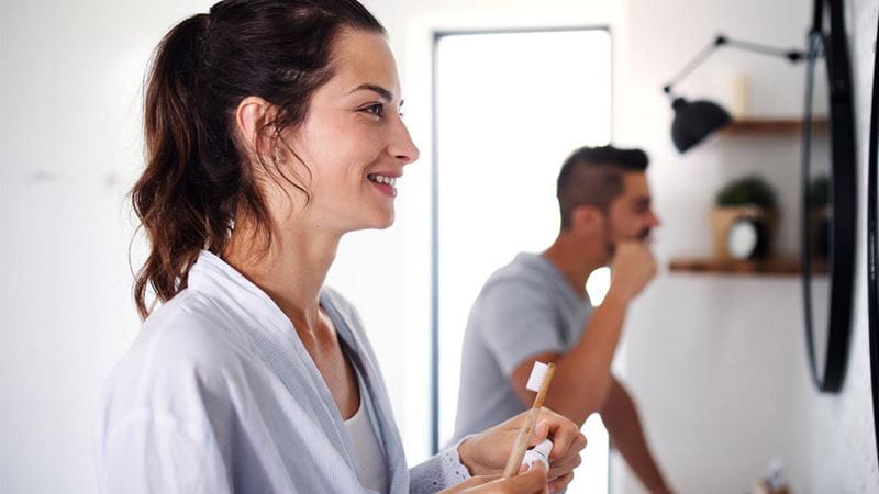 Couple brushing their teeth with toothpaste before bed