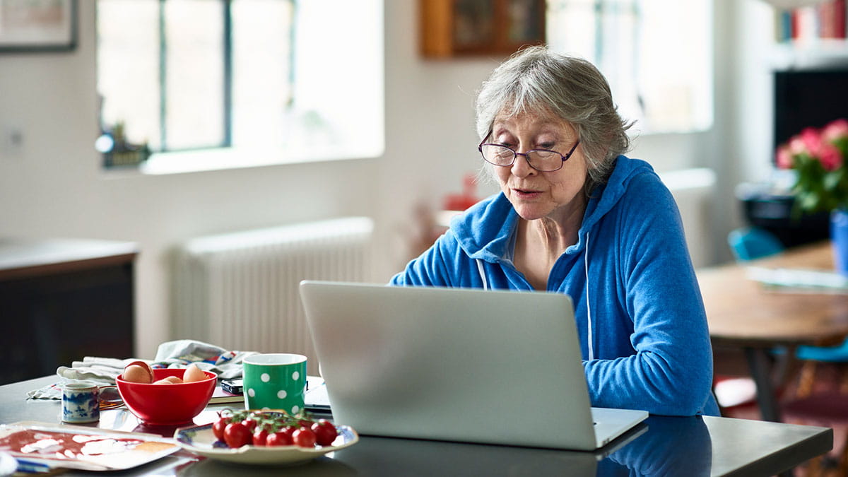 Elderly woman evaluating her health information online