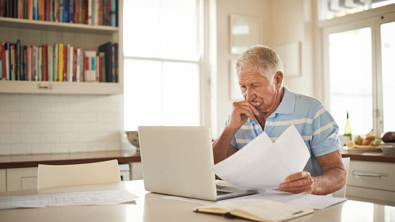 Older man looking at paper work