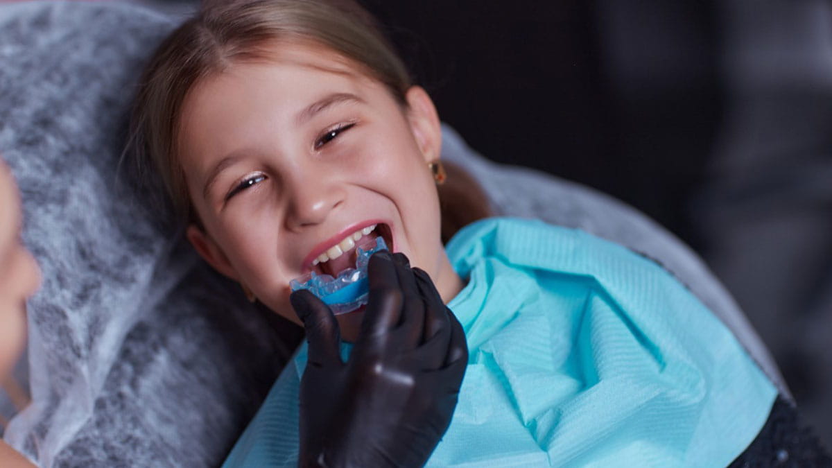 Child putting in a mouth guard