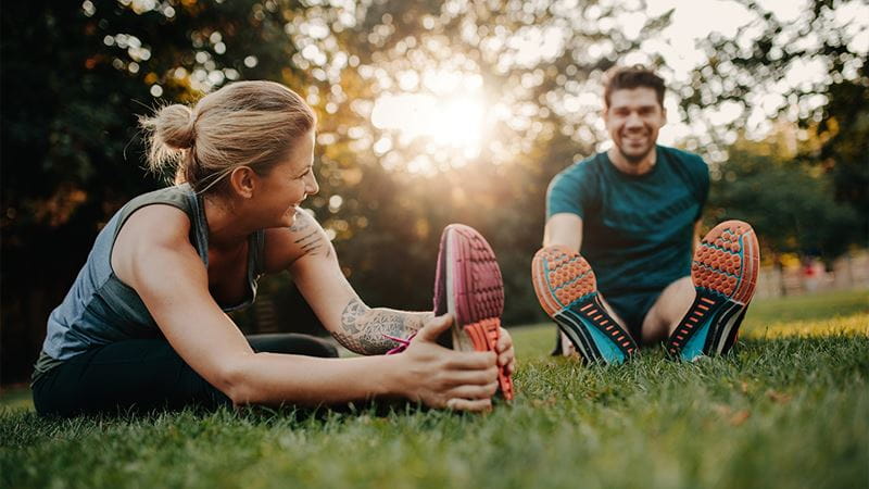 Man and woman stretching before exercise