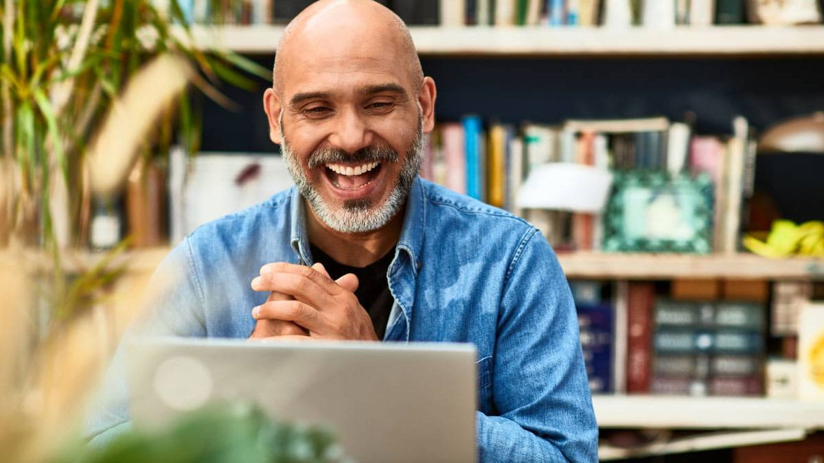 Man smiling looking at laptop