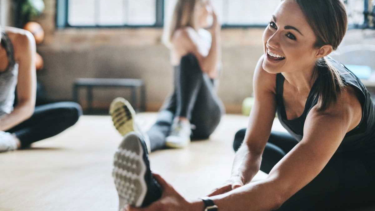 Young woman stretching at the gym