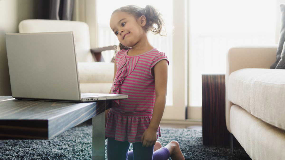 Young girl looking confused at laptop
