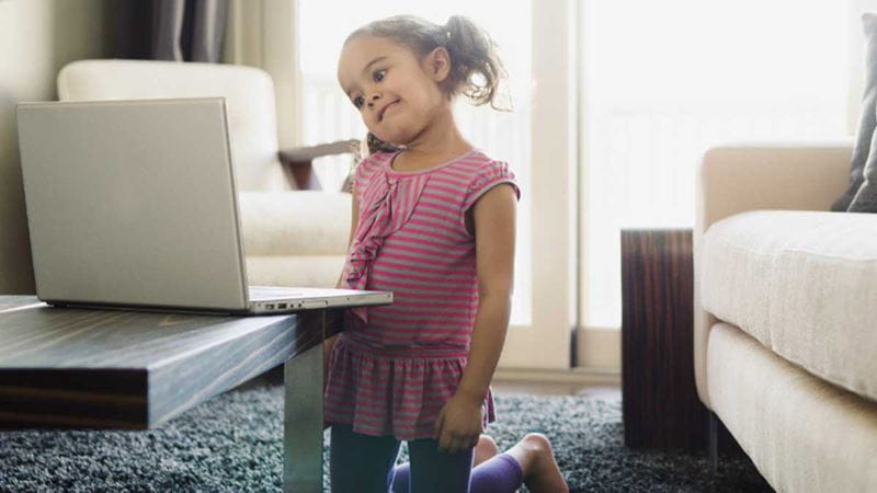 Young girl looking confused at laptop