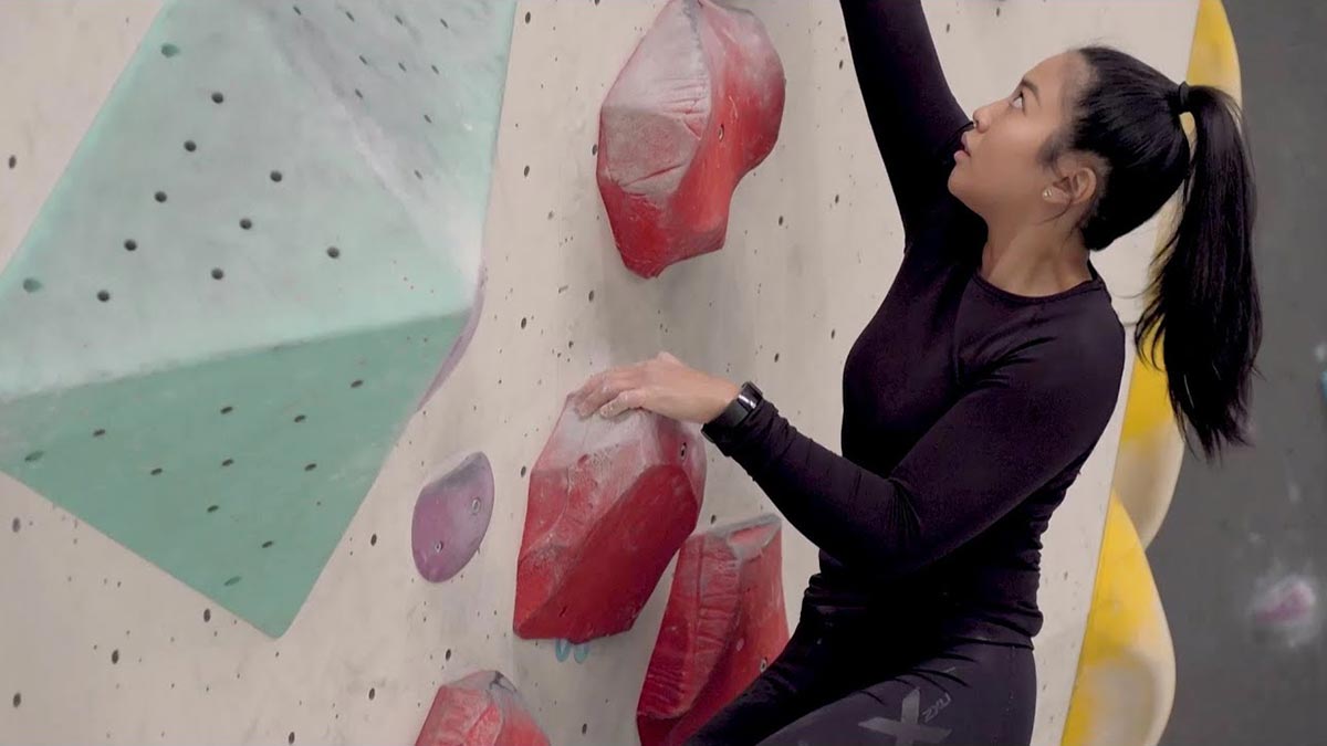 Leanne climbing an indoor rock climbing wall