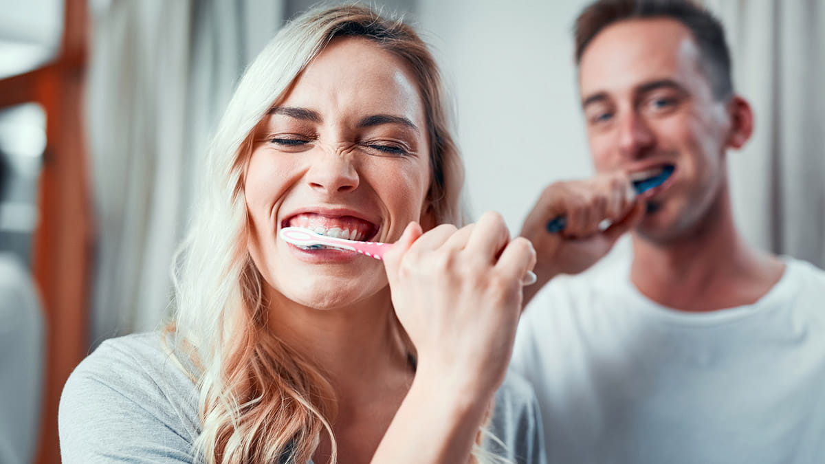 Couple brushing teeth
