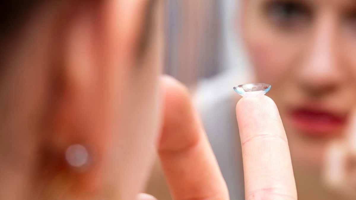 Woman putting a contact lens in