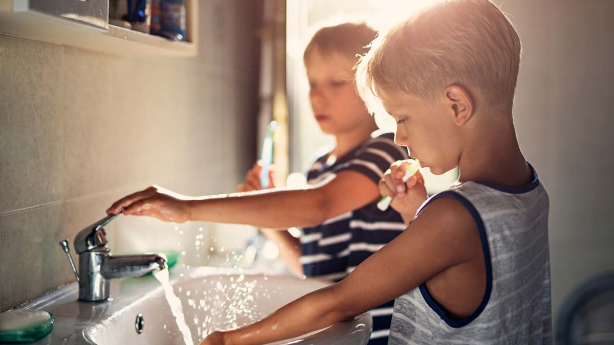 Young boys washing their hands