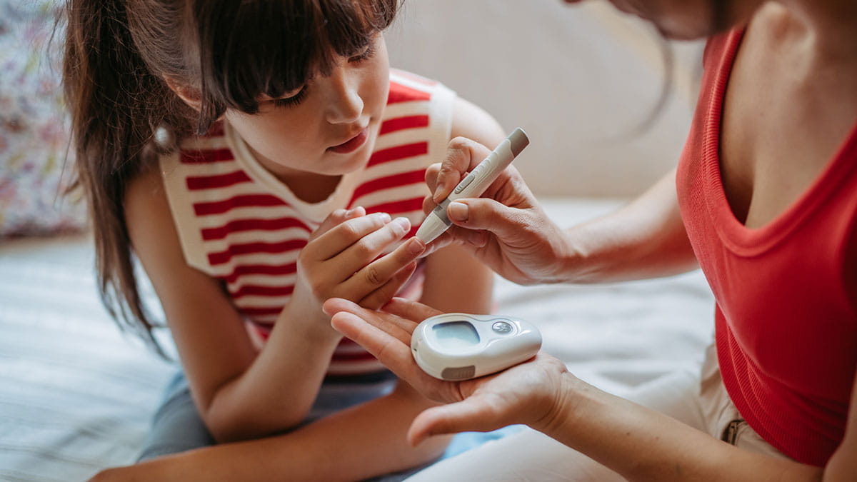 Girl getting her blood sugar tested