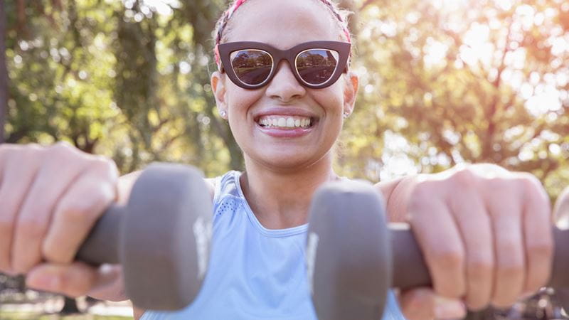 Woman in her 40s with dumbells