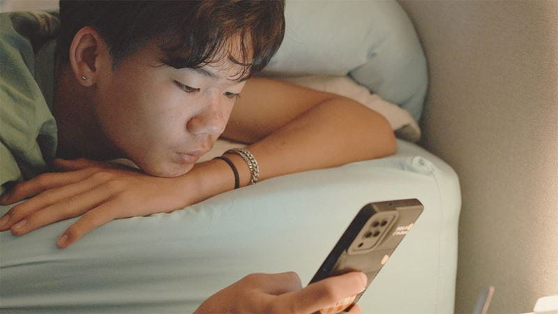 Teenager on his phone