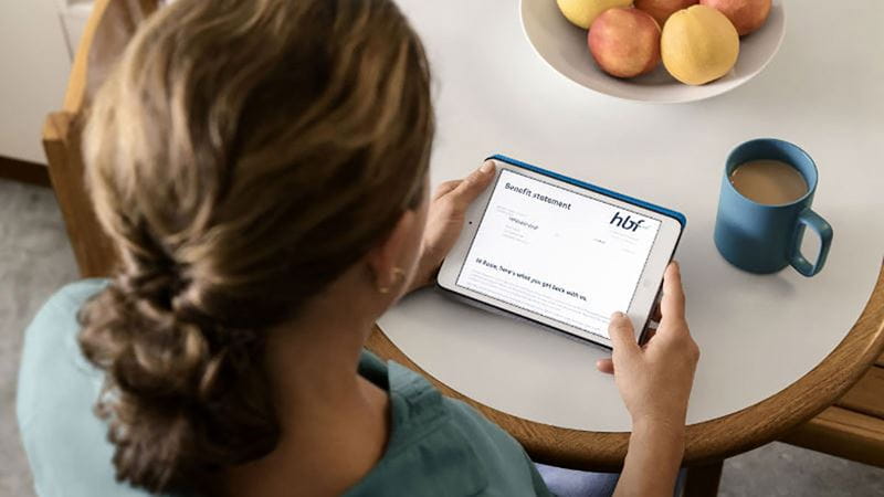 Woman accessing myHBF on tablet