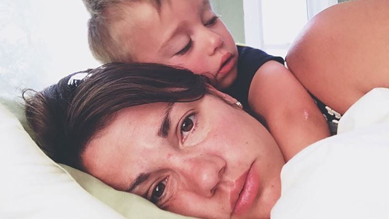 Crying baby hugging crying mother