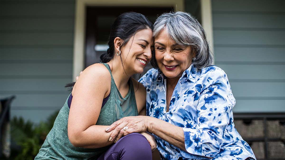 Two women hugging with their heads together