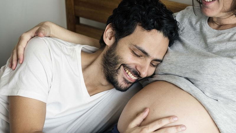 Dad feeling his partners pregnant stomach