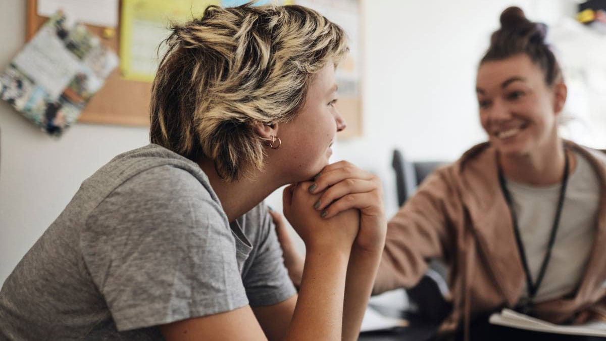 Smiling young women sitting with mental health professional