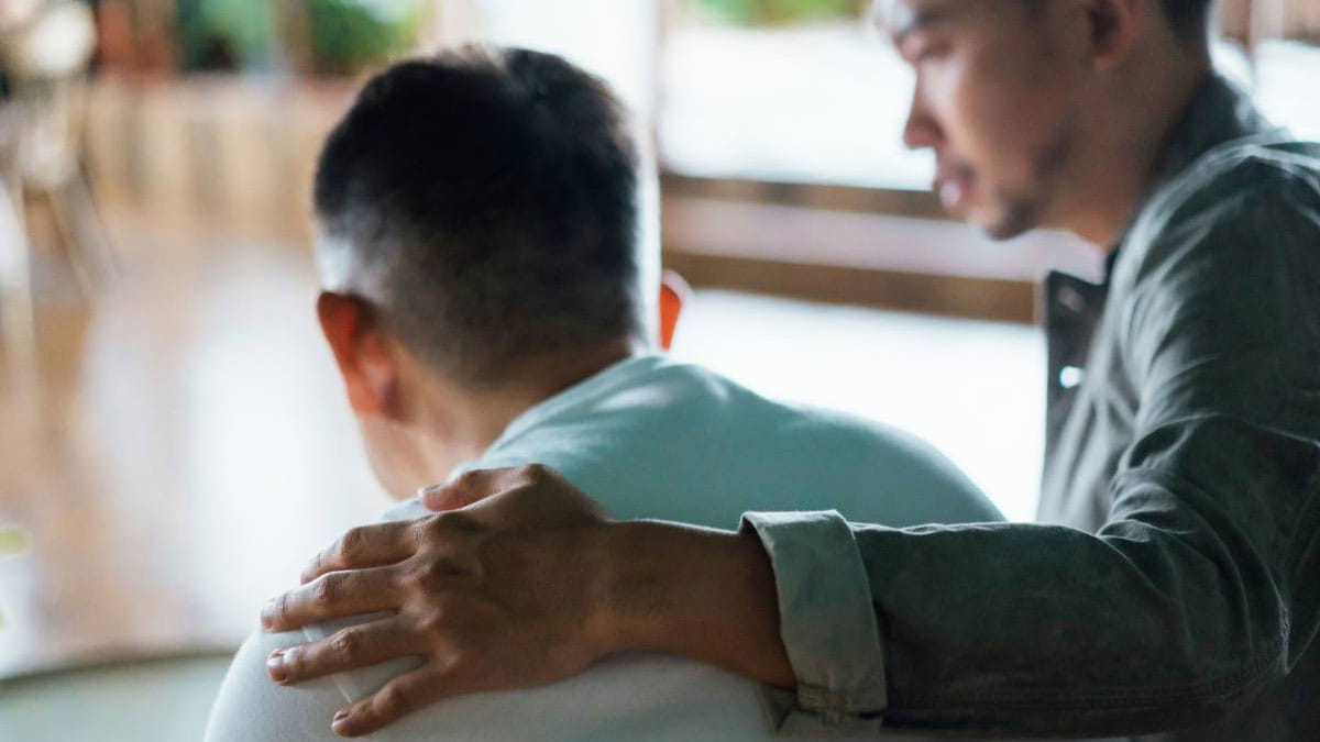 Man consoling patient