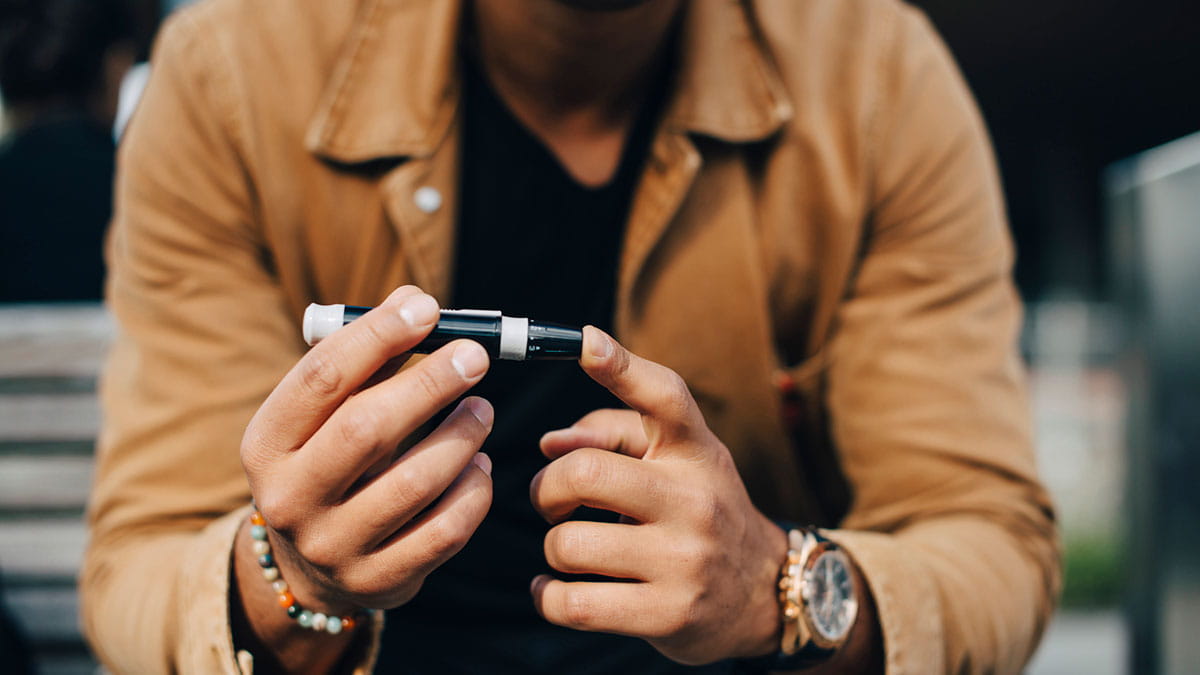 Man testing his blood sugar