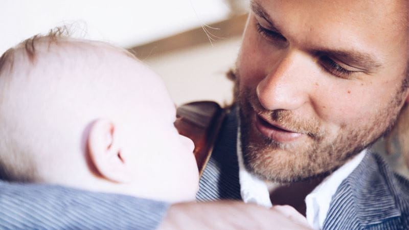 New father or dad admiring his baby
