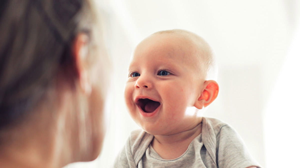 Infant smiling at mother