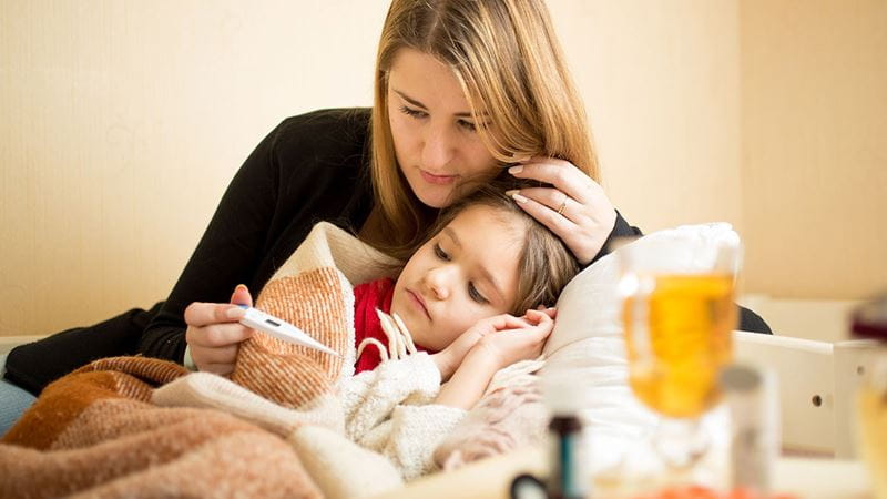 Mum taking daughter's temperature