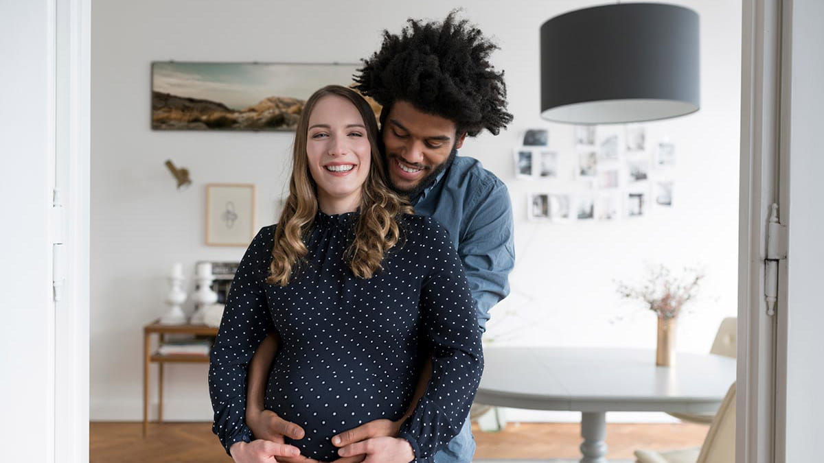 Man hugging pregnant partner
