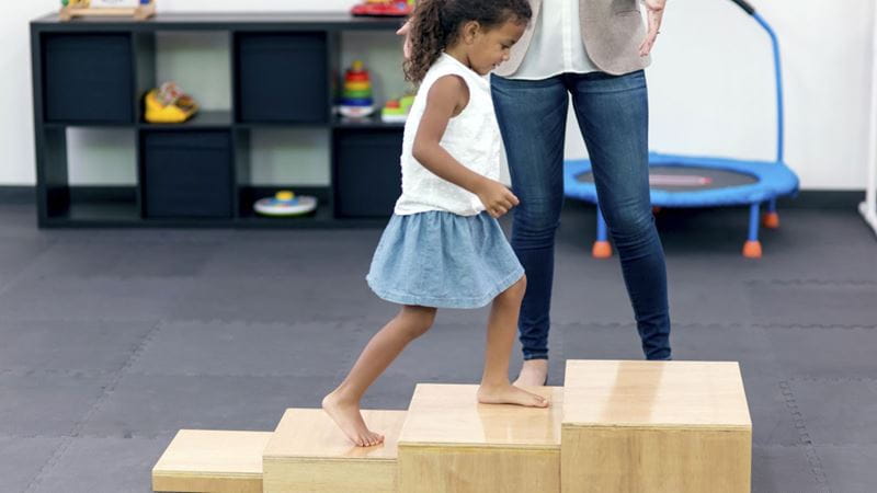 Young girl climbing up steps