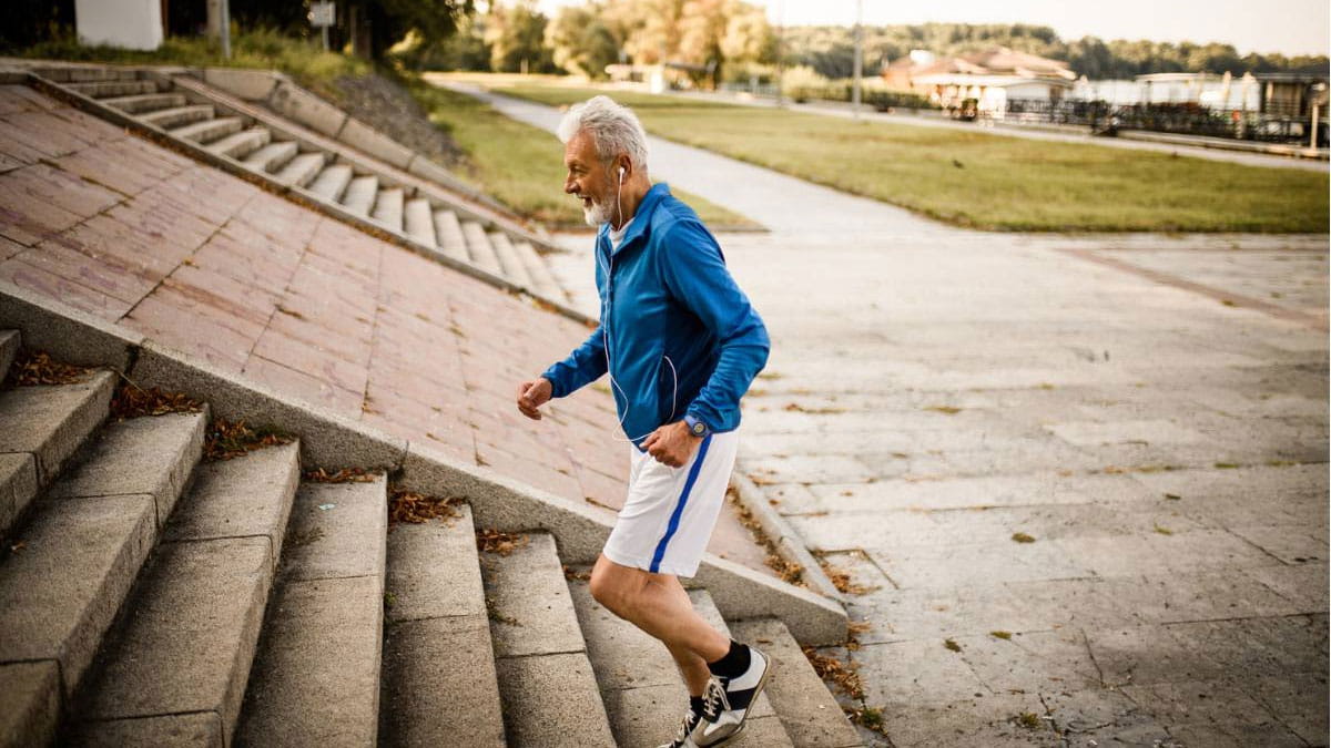 Older man running up stairs