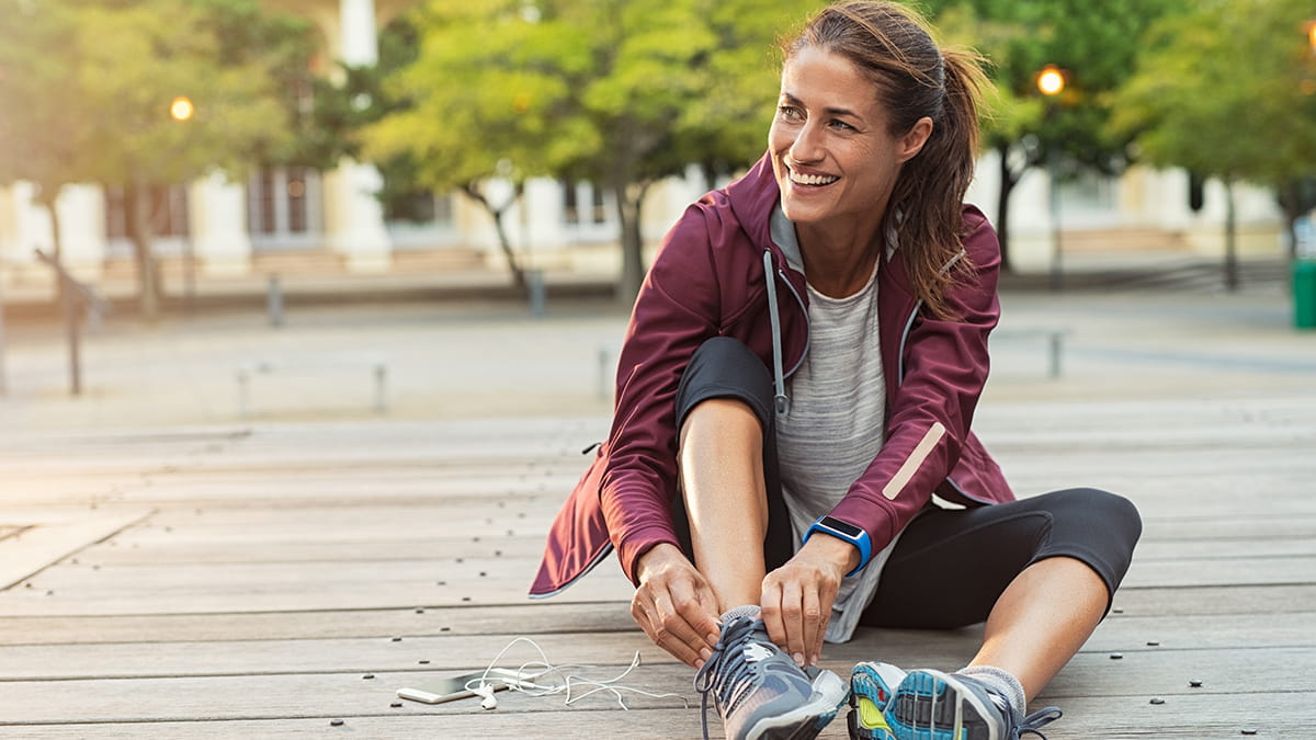 Woman tying shoes laces on running shoes