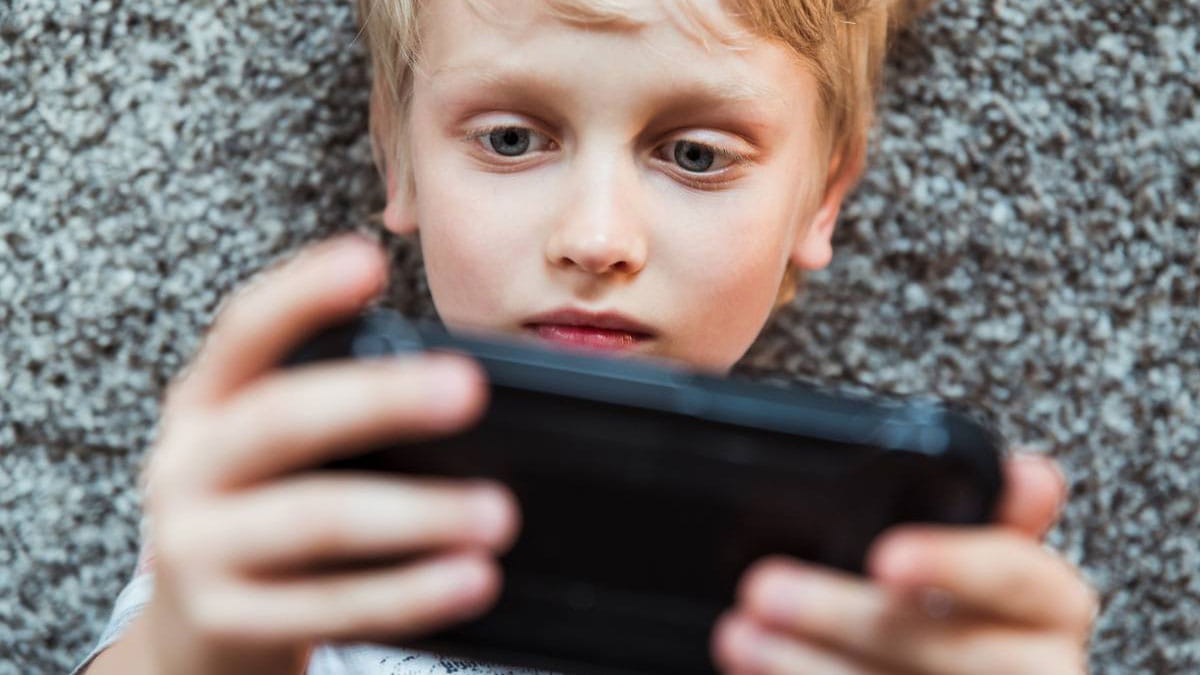 Young boy looking on iphone