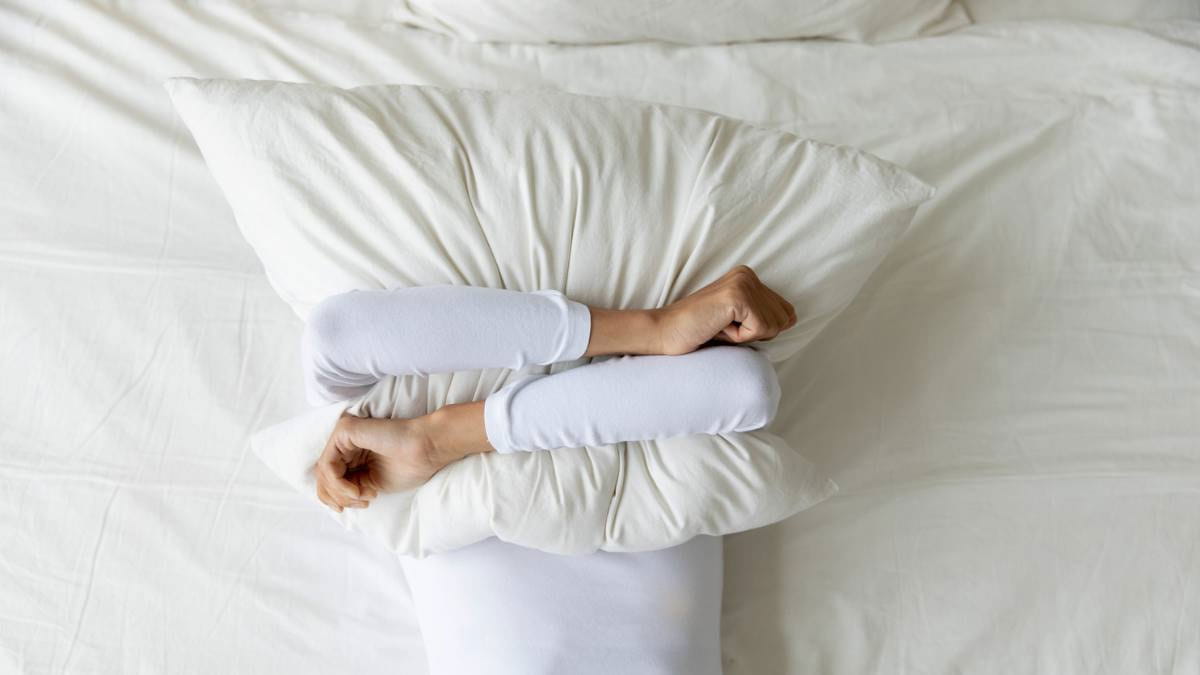 Person holding pillow