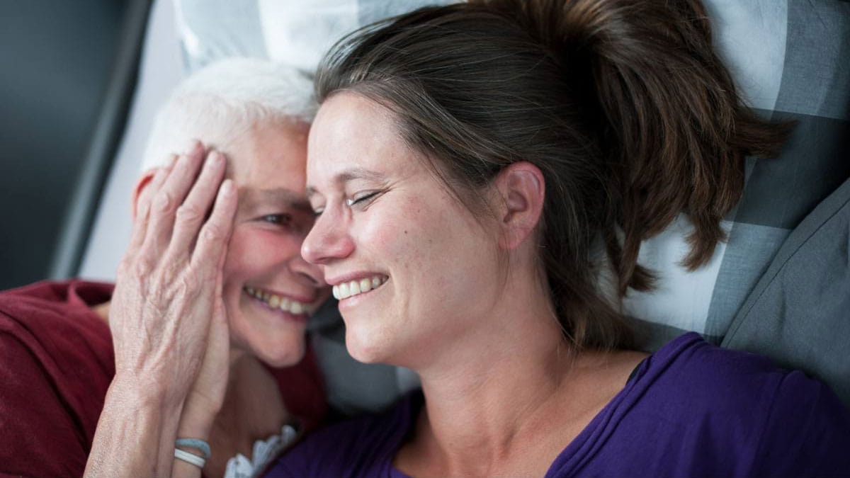 Young daughter consoling mother