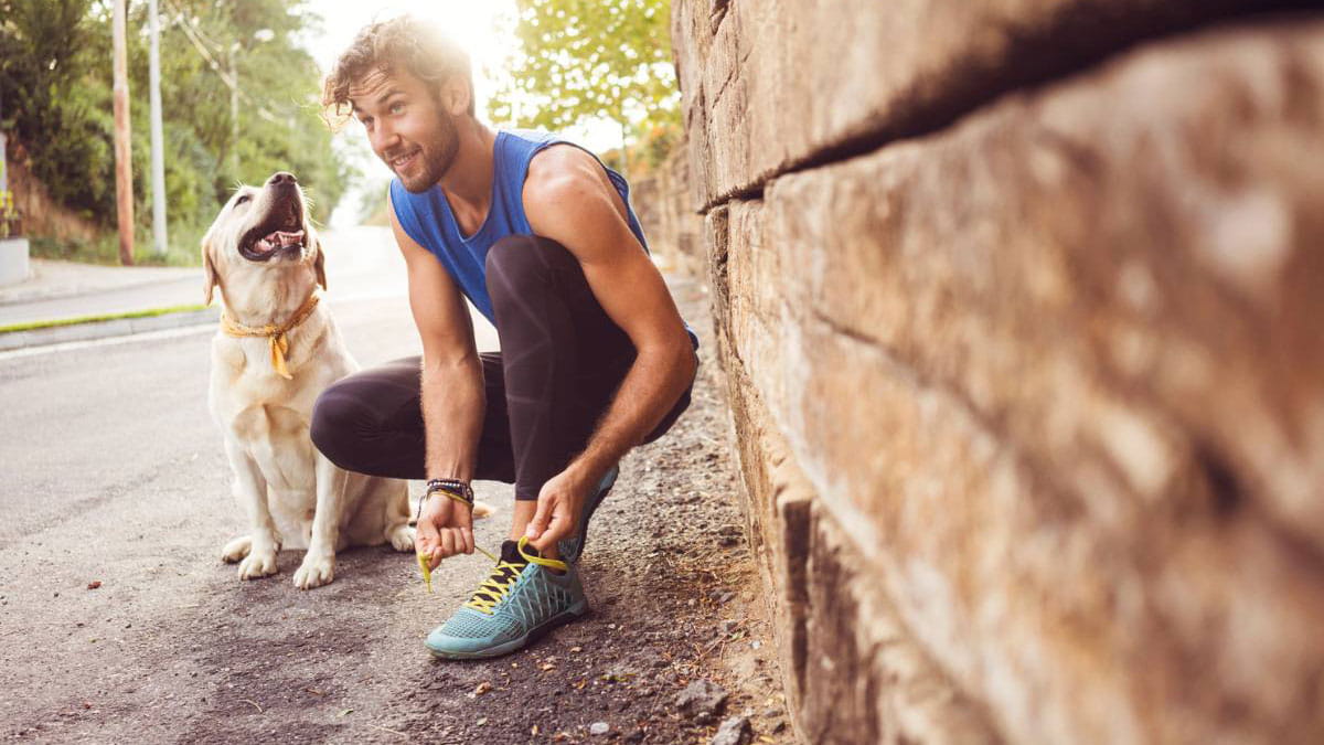 Male runner tying his shoe laces.